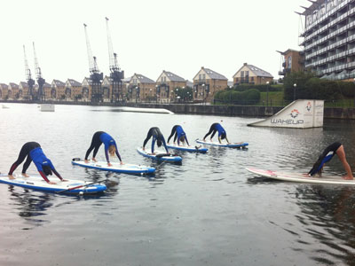 Do yoga on a paddleboard on water picture